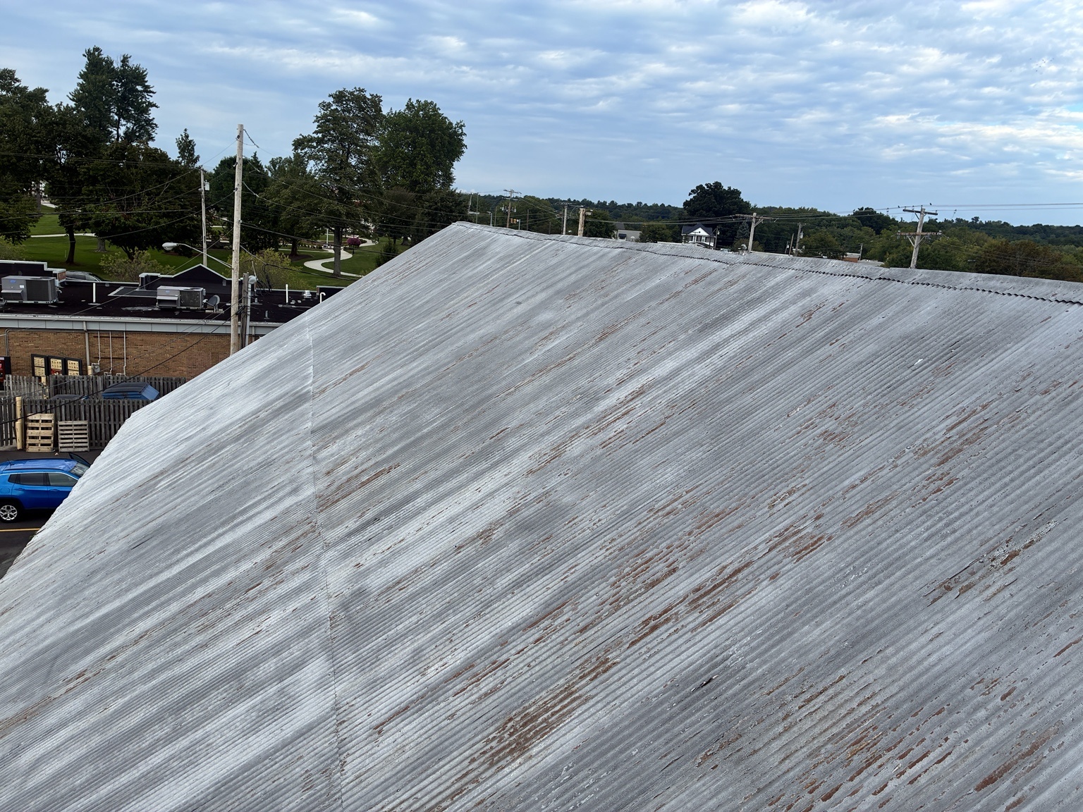 Freeman Barn corrugated metal roof with failing silver coating and exposed oxidation