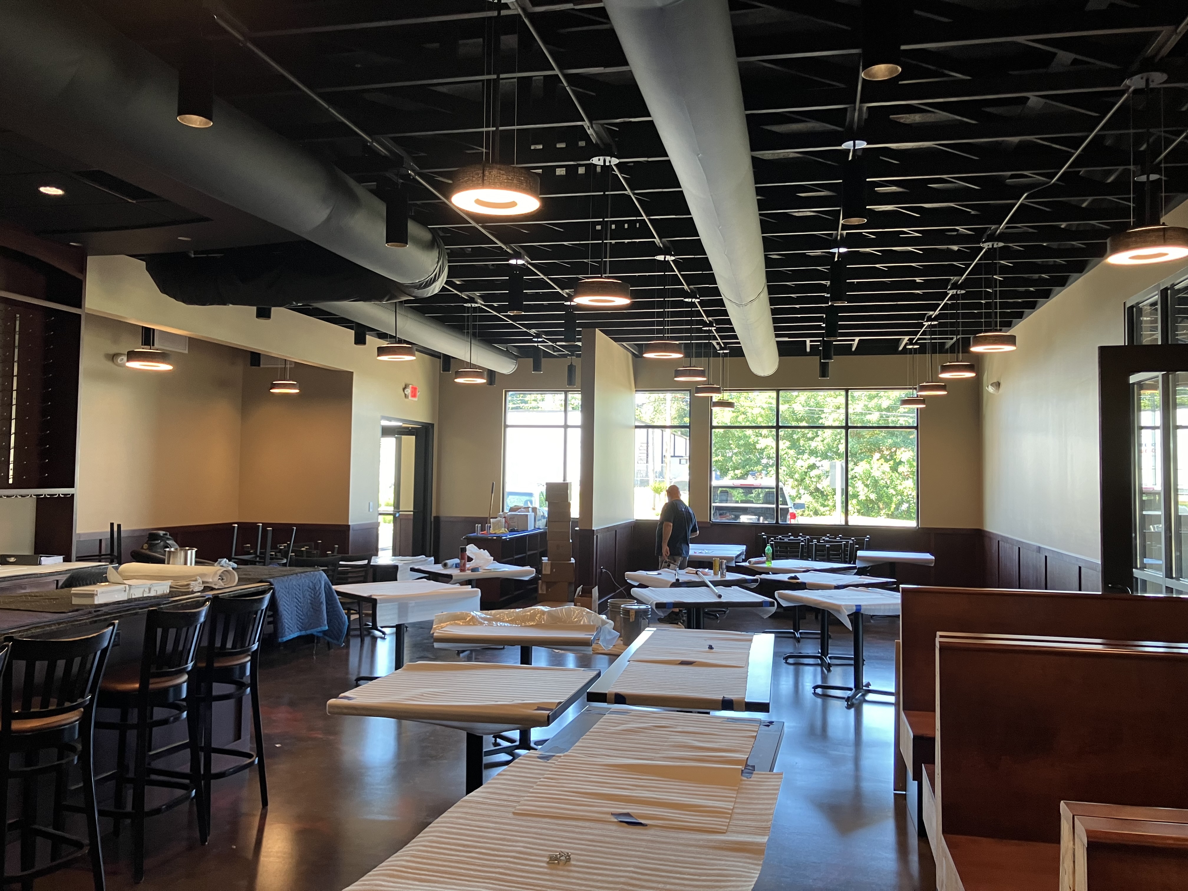 Commercial interior with a completed flat black open ceiling